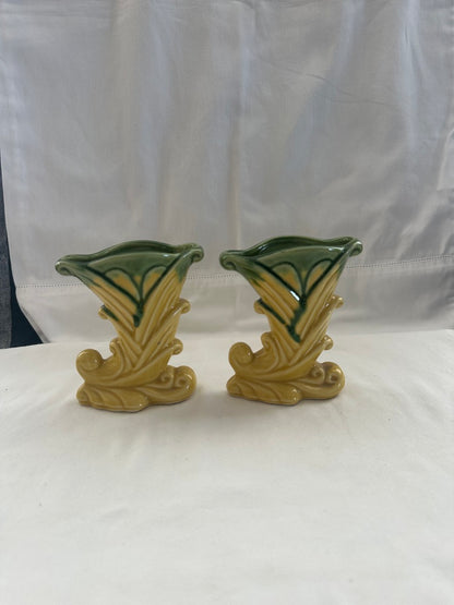 Pair of vintage Shawnee Pottery cornucopia vases standing front view against white cloth