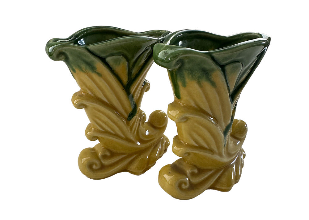Pair of vintage Shawnee Pottery cornucopia vases in yellow-green glaze, three-quarter angled view