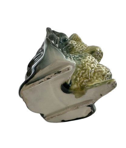 Pair of vintage Hull poodle vases tilted to show the unglazed ceramic bases and green leaf-form vessels
