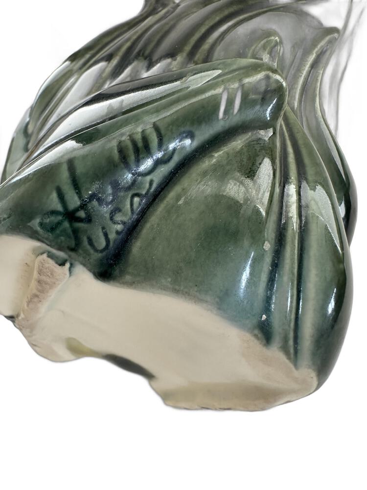 Close-up of the hand-painted 'Hull USA' maker's mark on the unglazed base of the poodle vase