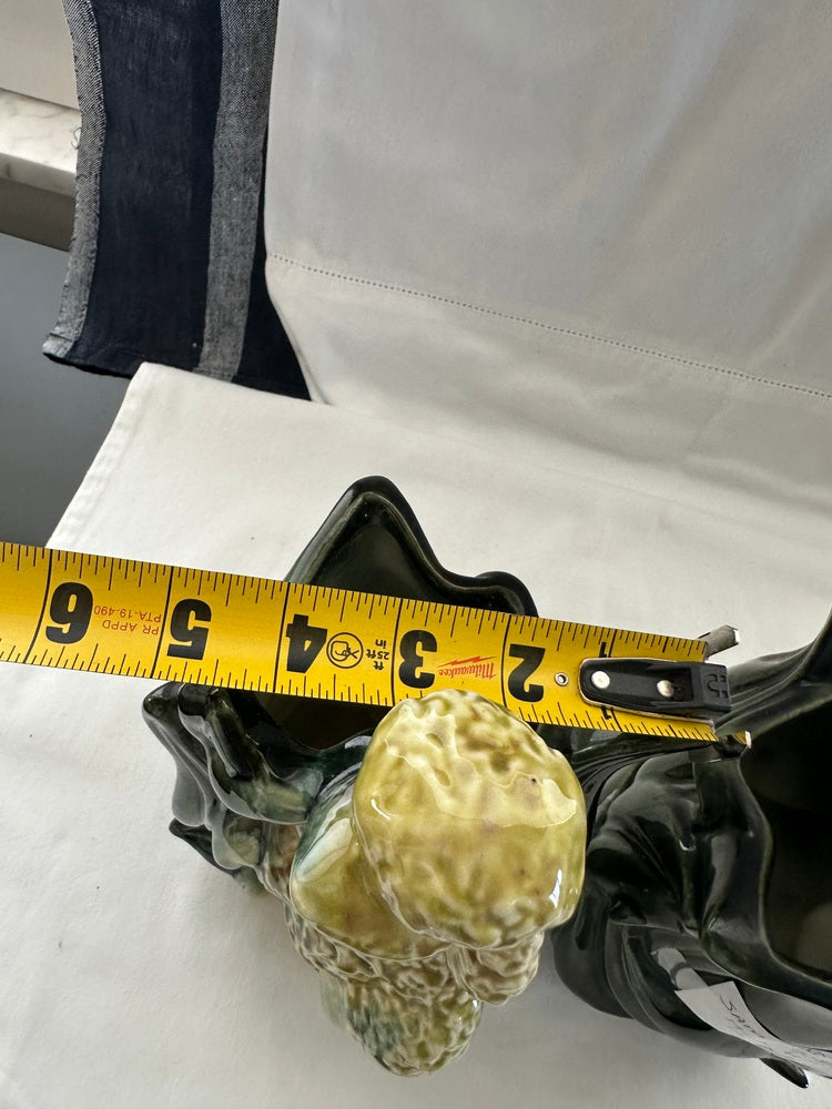 Vintage Hull poodle vase laid on its side with a tape measure across the top measuring its width