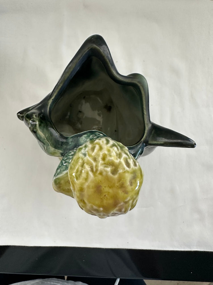Top view into a vintage Hull poodle vase, dark green leaf-form cavity with yellow-green poodle in front