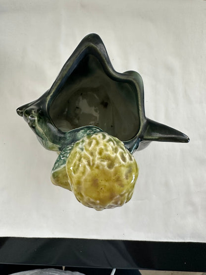 Top view into a vintage Hull poodle vase, dark green leaf-form cavity with yellow-green poodle in front