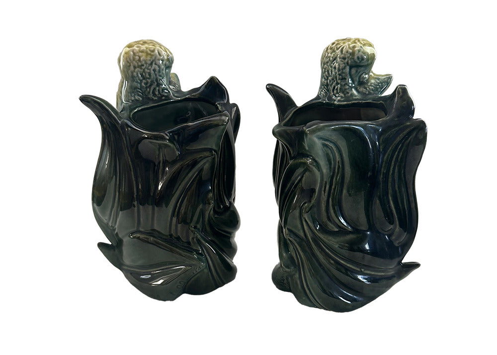 Pair of vintage Hull poodle vases from behind, dark green leaf-form vessel openings with poodle heads above
