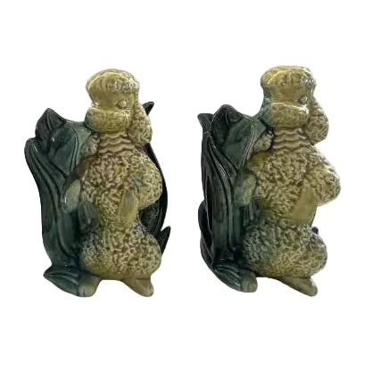 Pair of vintage Hull poodle vases, yellow-and-green glazed ceramic poodles seated against leaf-form vessels, front view