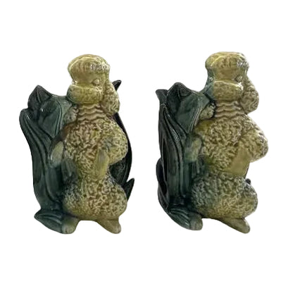 Pair of vintage Hull poodle vases, yellow-and-green glazed ceramic poodles seated against leaf-form vessels, front view