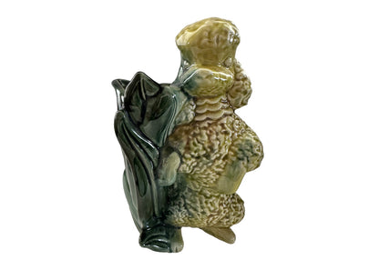 Vintage Hull poodle vase, single yellow-green glazed poodle figure beside a dark green leaf-form vessel, side view