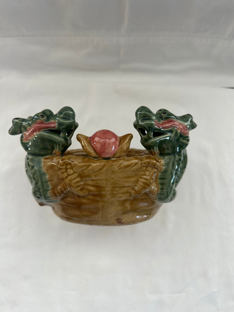 Vintage ceramic double dragon planter, front view with two green dragon heads and a raised pink pearl