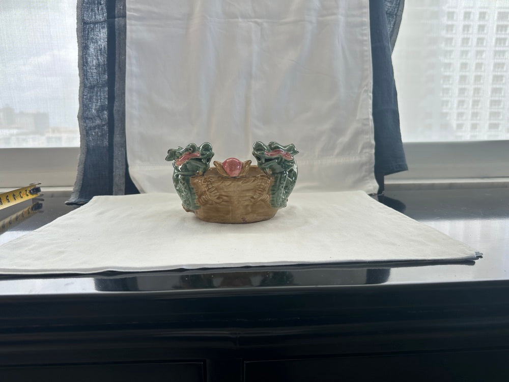 Ceramic double dragon planter on a windowsill table with city view, two dragon heads and pink pearl