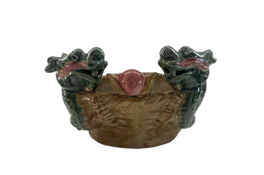 Vintage ceramic double dragon planter, front view with two green dragon heads flanking a pink pearl