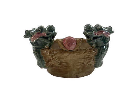 Vintage ceramic double dragon planter, front view with two green dragon heads flanking a pink pearl