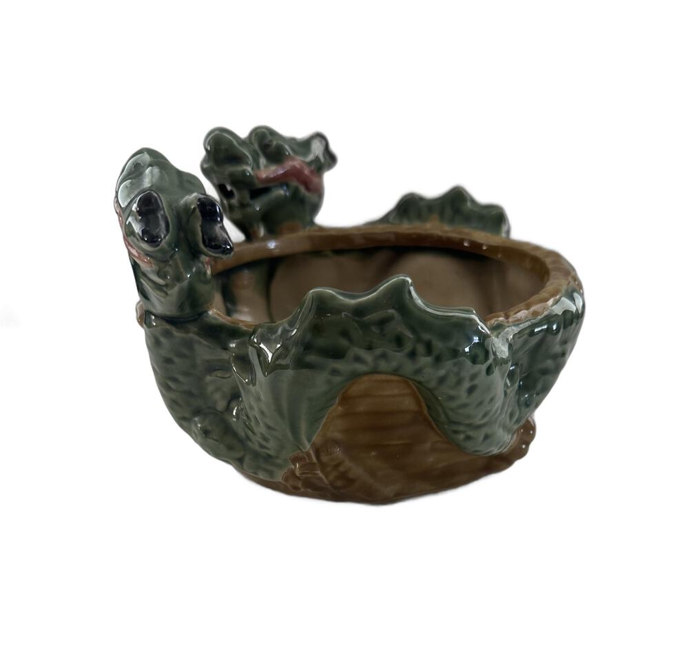 Side view of the ceramic double dragon planter showing the green scaled dragon body around brown bowl