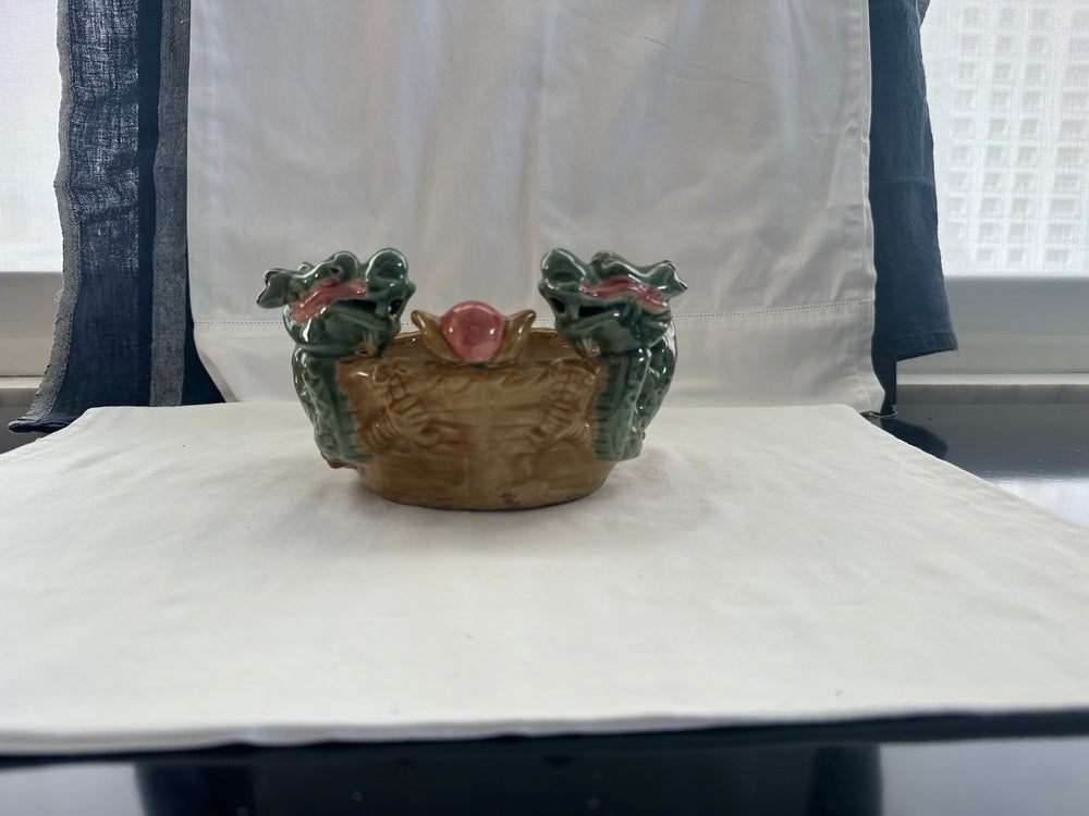 Vintage ceramic double dragon planter displayed on a windowsill, front view with two dragon heads
