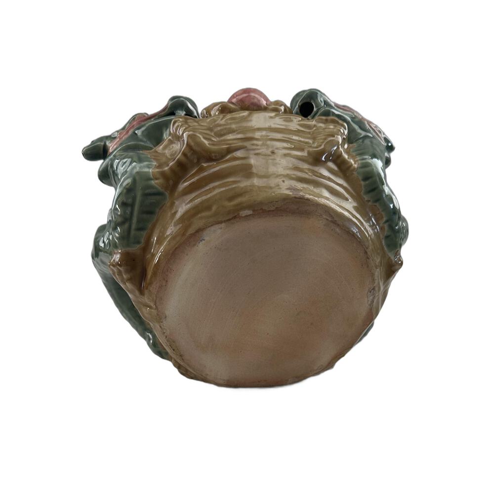 Underside of the ceramic double dragon planter showing the unglazed terracotta base