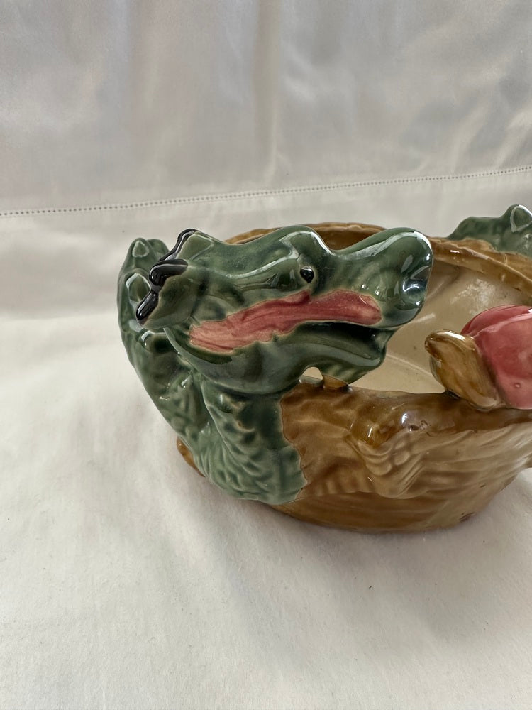 Close-up of the green dragon heads and central pink pearl on the ceramic double dragon planter