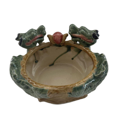 Ceramic double dragon planter viewed from above, cream bowl interior between two green dragon heads