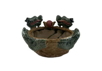 Front view of the ceramic double dragon planter showing the open bowl and two dragon-head handles