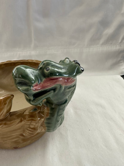 Close-up of one green glazed dragon head on the ceramic double dragon planter, with pink mouth detail