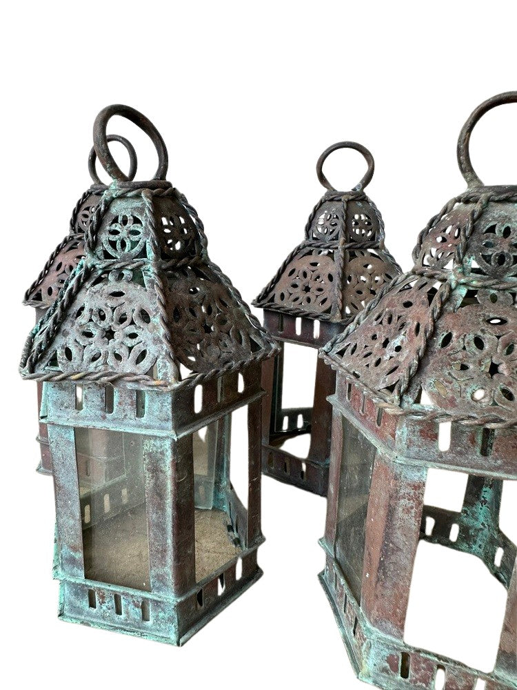 Vintage copper lanterns, close-up detail of the pierced domed tops and aged green-brown patina