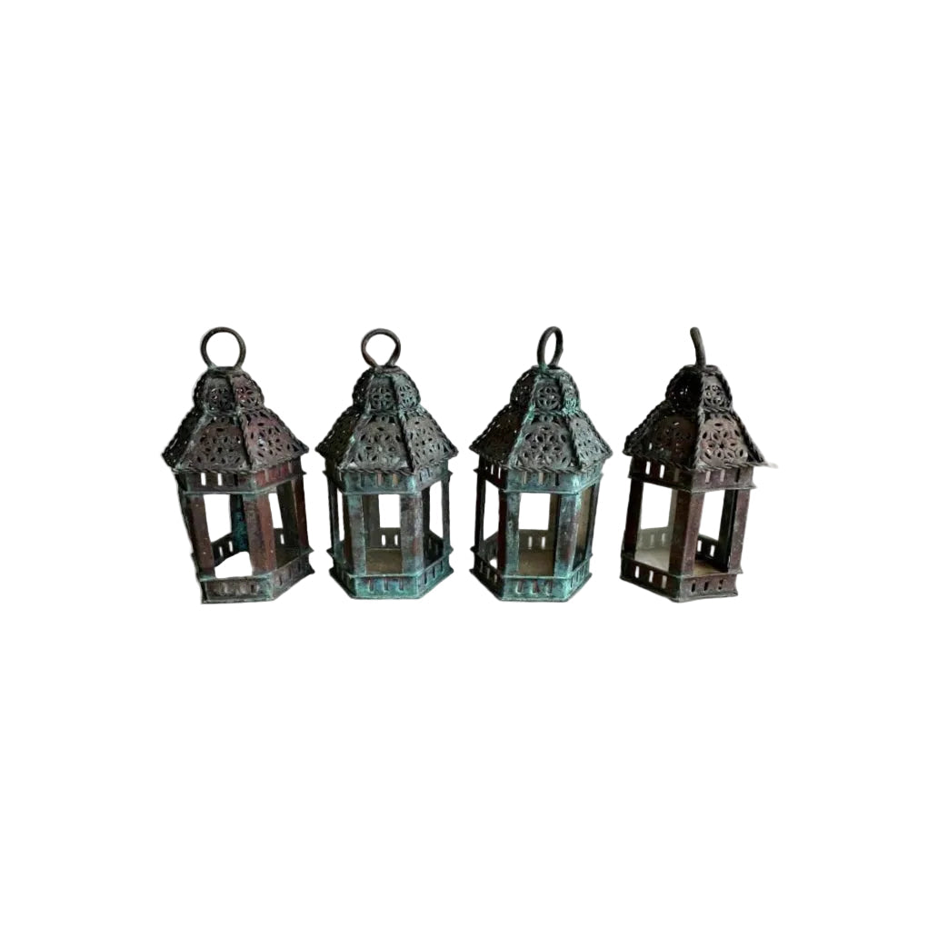 Vintage copper lanterns: set of four small pierced lanterns with glass panels, lined up upright