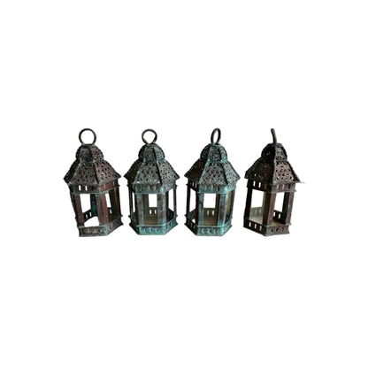 Vintage copper lanterns: set of four small pierced lanterns with glass panels, lined up upright
