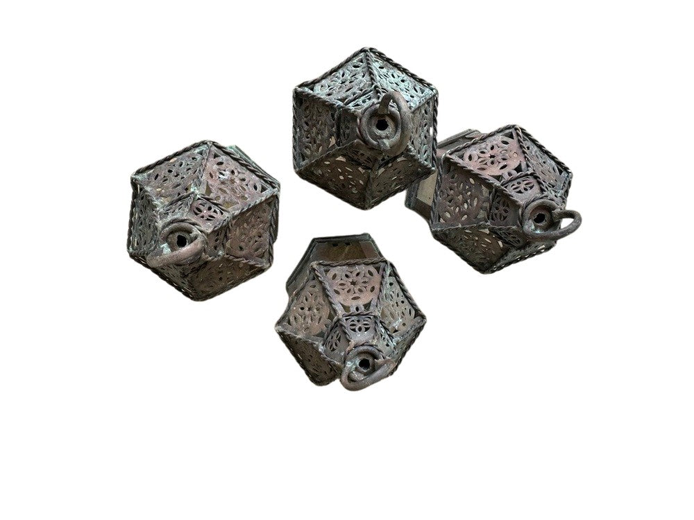 Vintage copper lanterns, four lanterns laid on their sides showing loop handles and pierced tops