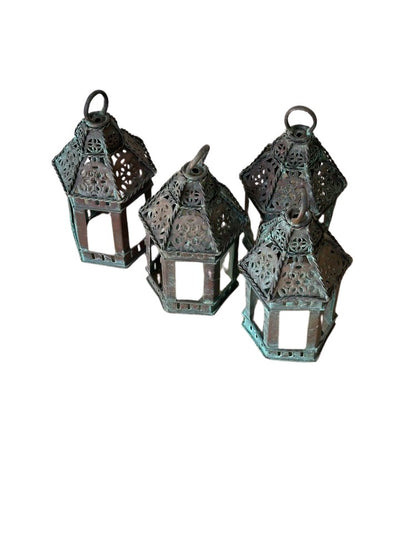 Vintage copper lanterns, four small pierced lanterns grouped at varying angles