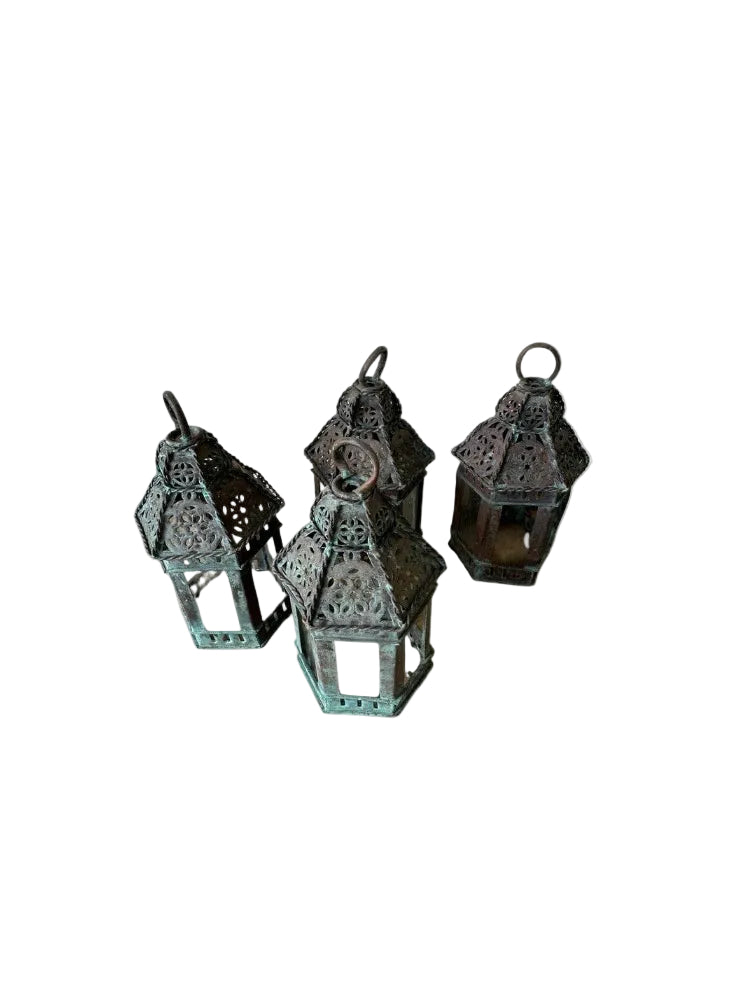 Vintage copper lanterns, four small patinated lanterns clustered at varying angles