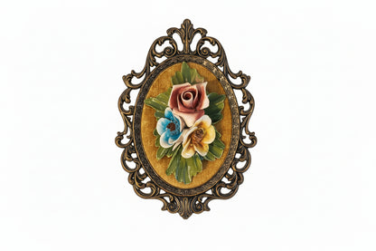 Vintage Capodimonte-style porcelain floral wall plaque, pink rose with blue and yellow blooms on gold velvet in ornate frame