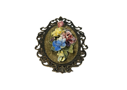 Capodimonte floral wall plaque viewed slightly angled, porcelain roses on green velvet in gilt-metal frame