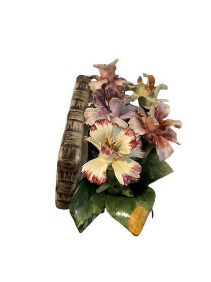 Side view of the Capodimonte porcelain flower arrangement showing the woven-basket ceramic base