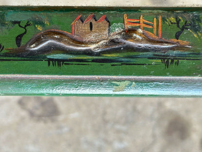 Detail of hand-painted landscape scene with house and trees on green lacquered table rail