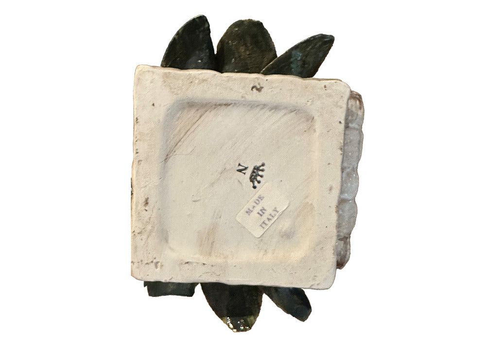 Underside of the Capodimonte basket showing the blue crowned-N mark and a 'Made in Italy' label