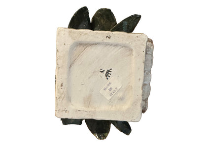 Underside of the Capodimonte basket showing the blue crowned-N mark and a 'Made in Italy' label