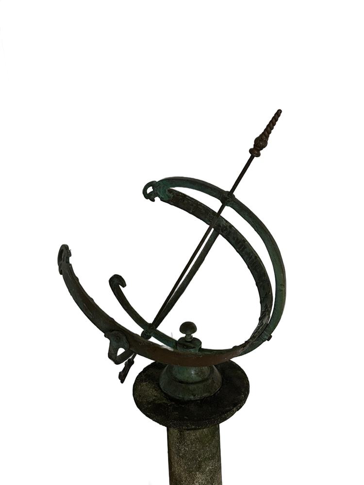 Close-up of the bronze armillary sphere, verdigris rings and central arrow gnomon, mounted on its base