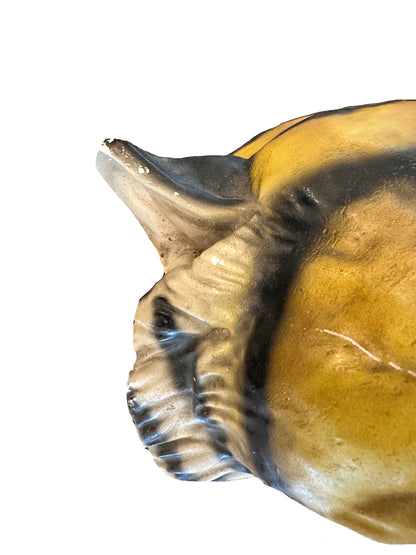 Close-up detail of vintage ceramic tiger head's glazed ear and shoulder