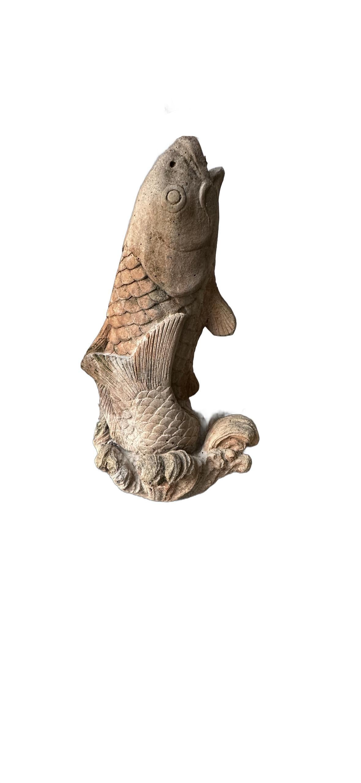Vintage concrete koi fountainhead, three-quarter view of the leaping carp on a wave base
