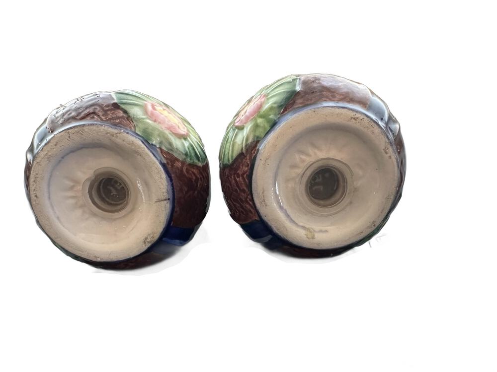 Underside view of ceramic salt and pepper shakers showing stopper holes and unglazed bases