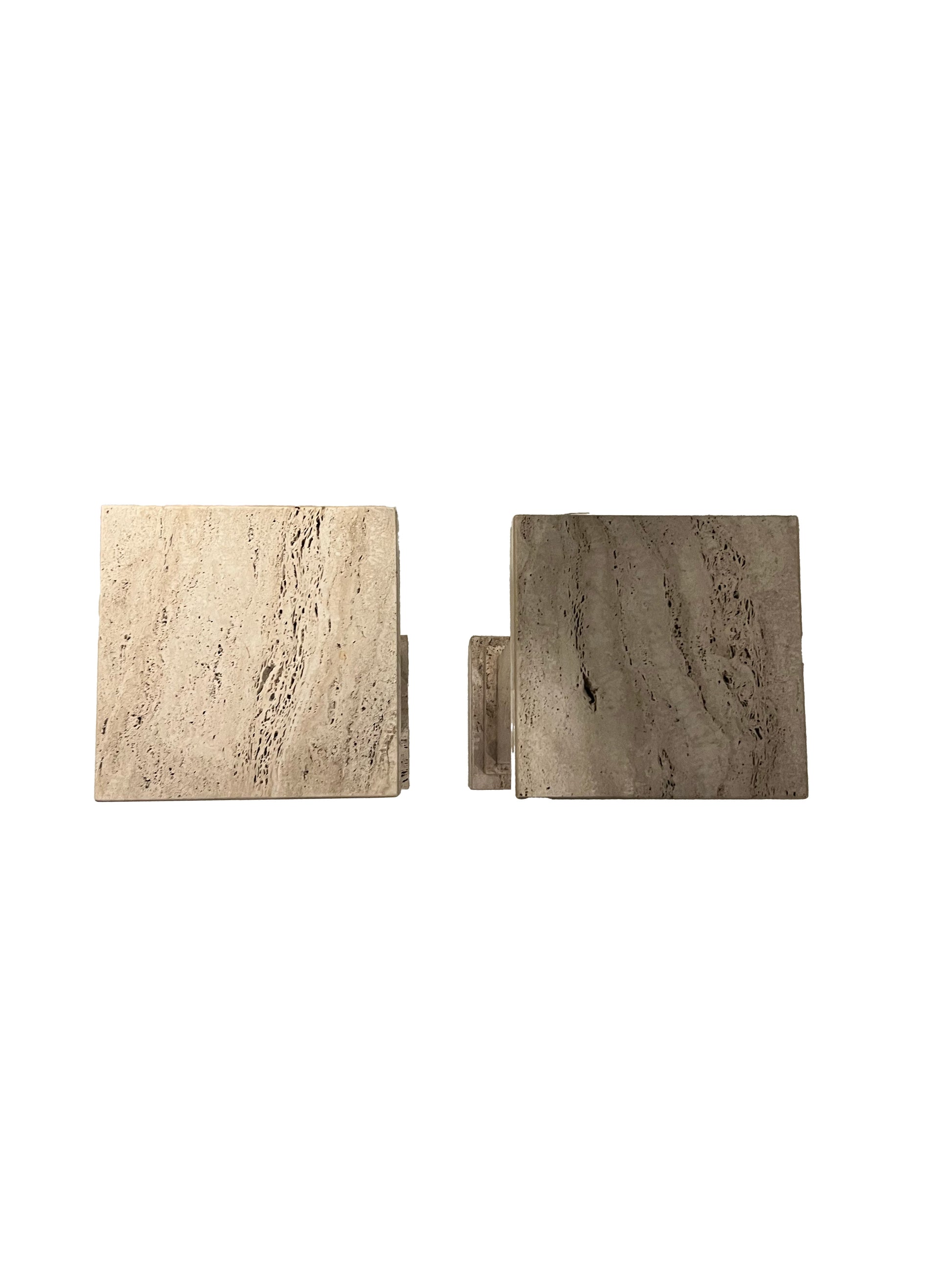 Top-down view of the two square travertine pedestal tops showing natural veining.