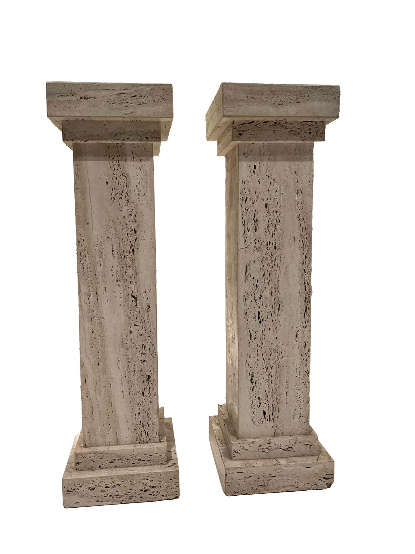 Pair of MCM travertine limestone pedestals, front view of square columns on stepped bases.