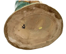 Underside of majolica heron and bamboo vase, unglazed tan oval base