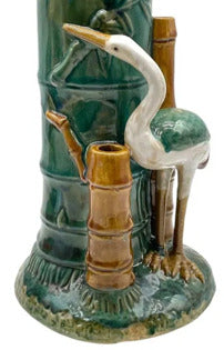 Majolica heron and bamboo vase, angled view of white heron against green bamboo trunk