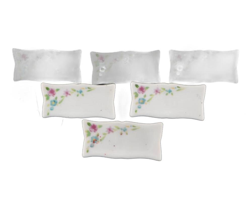 Six pillow-shaped porcelain bases, three with hand-painted pink-and-blue floral sprays and three plain