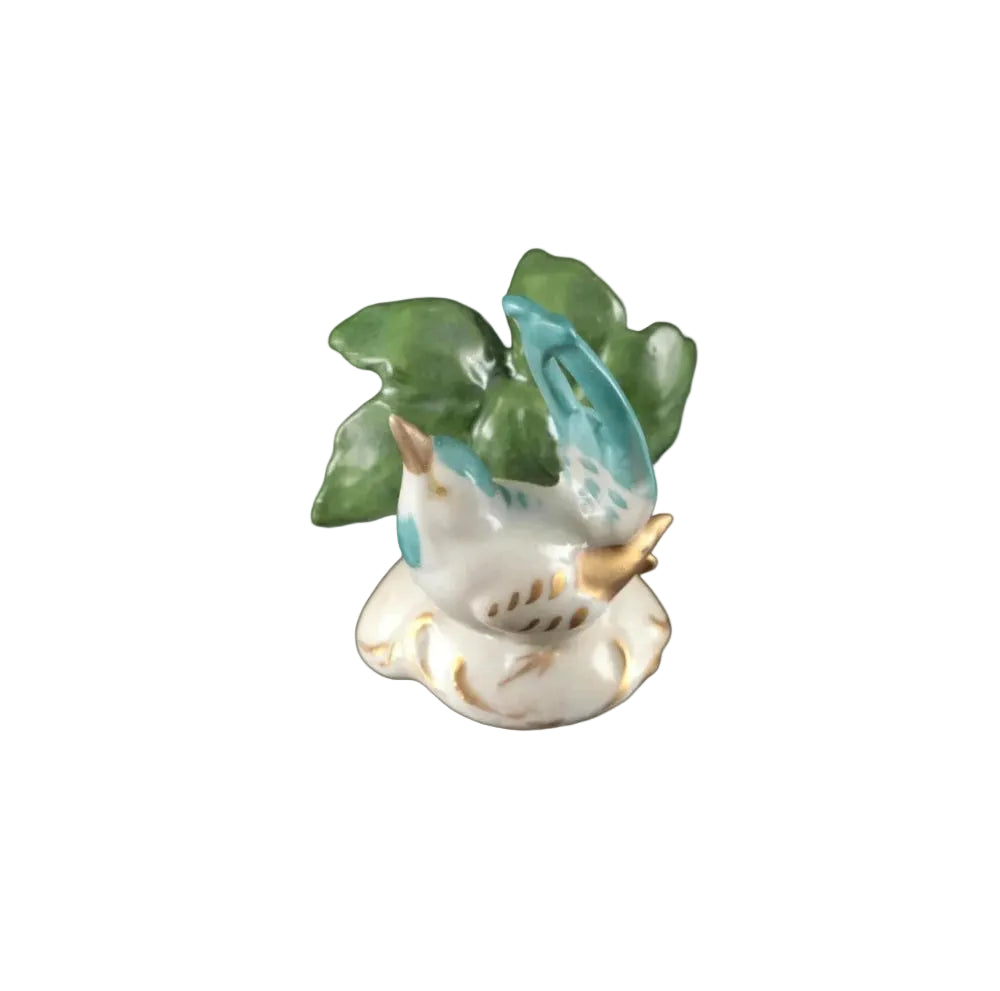 Single place card holder, turquoise-and-white porcelain bird with gilt beak on a green leaf base
