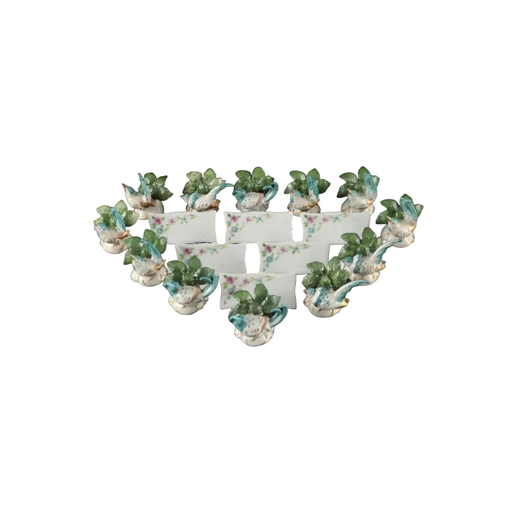 Full set of porcelain place card holders, turquoise birds among green leaves on white scalloped bases