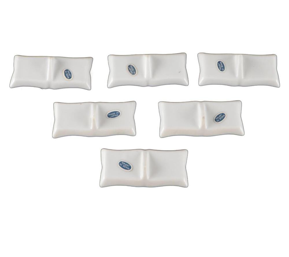Undersides of six place card holders, pillow-shaped bases with blue 'Made in Japan' maker's marks