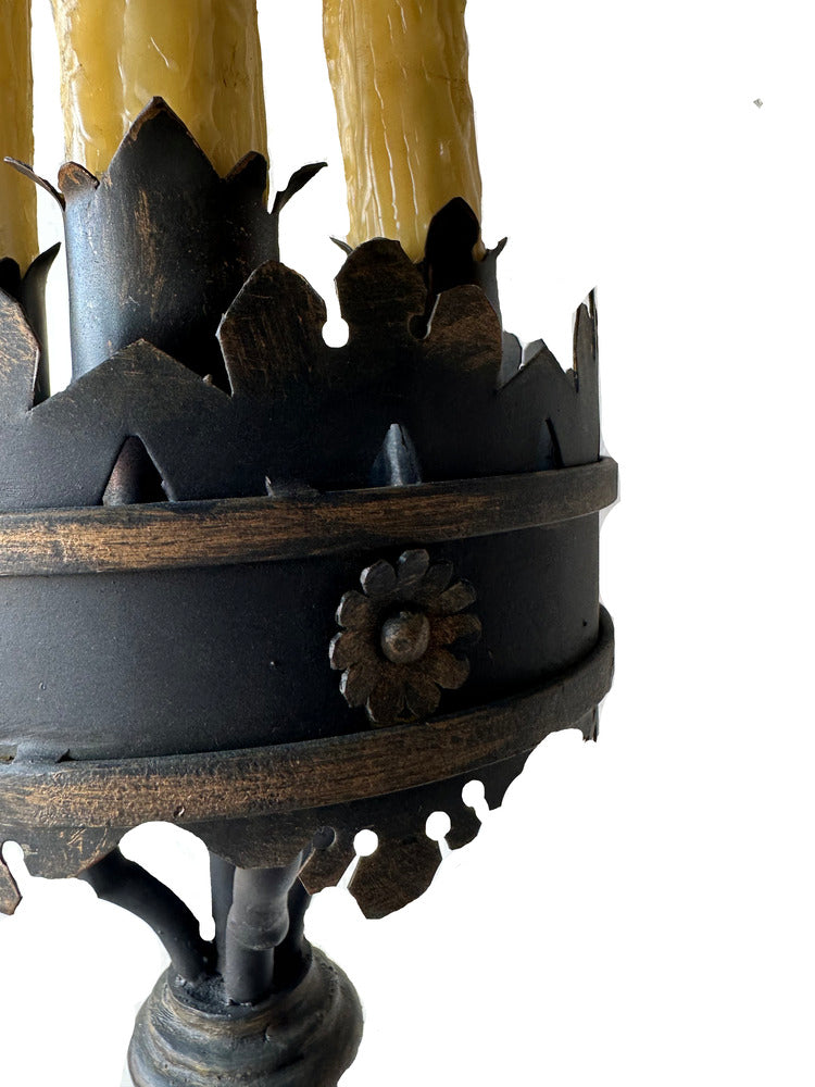 Close-up of the lamp's crown-shaped iron gallery with a rosette medallion and faux-candle sleeves