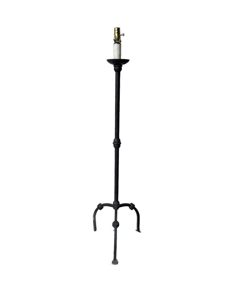 Vintage black iron floor lamp on white, slender column with three arched legs
