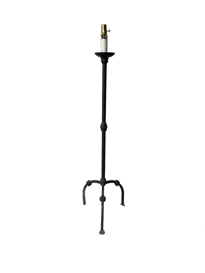 Vintage black iron floor lamp on white, slender column with three arched legs