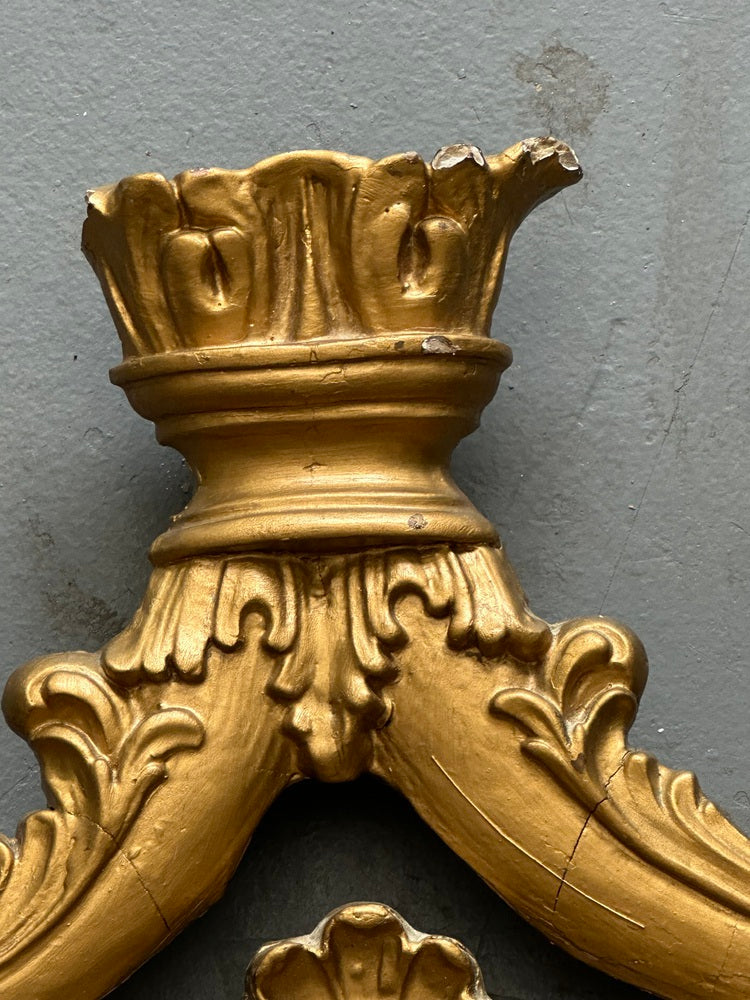 Vintage carved giltwood frame, close-up of carved crown finial showing gilding wear